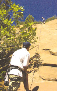 Brian Shelton belays for Major Christopher Wendland Steve
Wood of the Fort Carson 7th Infantry Division as part of the rock-climbing demonstration