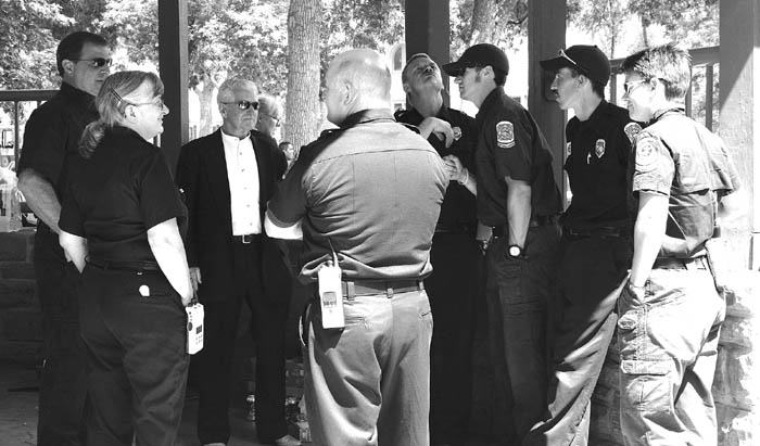 Retired Battalion Chief Jim Larsen (third from left) swaps stories with firefighters from Stations 3 and 5 during the 
Organization of Westside Neighbors (OWN) Picnic at Bancroft Park July 29. He died Aug. 7.
Westside Pioneer photo