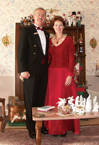 Welling and Sallie Clark pose in front of their fireplace nutcracker collection in the front 
room of the Holden House.