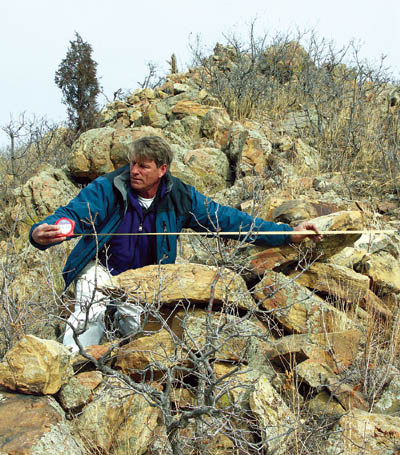 Steve Snyder measures one of the rocks in a man-made wall of mysterious origins 
in the citys Red Rock Canyon Open Space. His archeological study will be incorporated into the management plan being 
developed for the recently purchased property by the Colorado Springs Parks & Recreation Department.