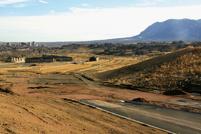 The paved portion of the Centennial Boulevard extension,
built by Colorado Springs Health Partners, is at  right, while
south of it is a few hundred feet of rough grading and then the unpaved segment going past the Indian Hills Village subdivision to Van Buren Street. South of that, no road has been built.
Westside Pioneer photo