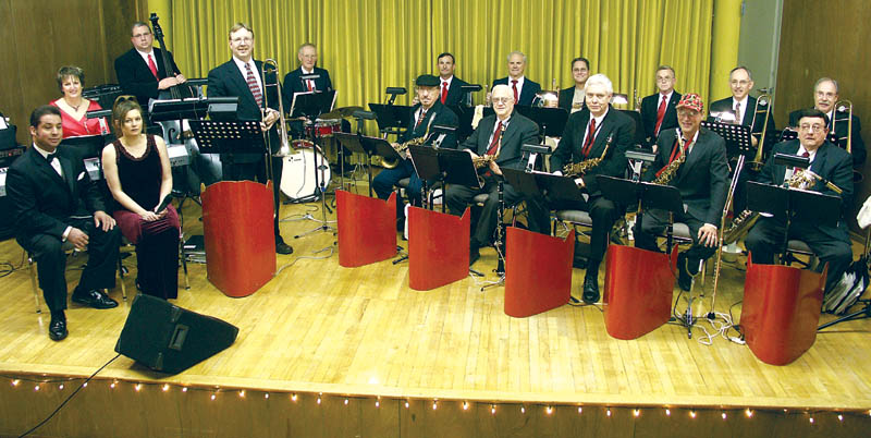 ABOVE: New Century Big Band 
members put down their
instruments briefly for a group photo. Sitting at left are
singers Randy and Michelle Rodriguez. Standing with
trombone is band leader Bill Emery.
Westside Pioneer photo