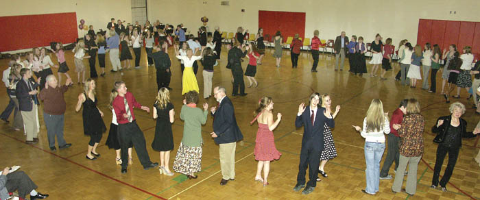 Gathered in a big circle, participants in Coronado Highs
Senior Citizens Ball Feb. 23 dance the hokey-pokey to the
music of the New Century Big Band (in far corner), which
had been hired for the night by the Student Council.
Westside Pioneer photo