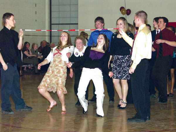 No one complained that Ruby Wyatt (third from left,
surrounded by Coronado High students) fudged a little to
get under the bar during the Limbo Rock song at the
Senior Citizens Ball in the schools auxiliary gym Feb. 23.
The Student Council organized the annual event, including
hiring a brass band.
Westside Pioneer photo