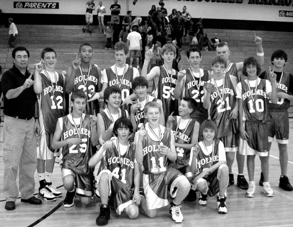 The Holmes Middle School basketball team members hold up
fingers signifying theyre number one after winning the
City Classic championship over Jenkins in the title game
March 1 on the Mitchell High School court. Front row,
kneeling (from left): Luke Brown, Drew MacMillan, Tate
Lagasca. Second Row, kneeling (from left): Dan Egger,
Josh Knotek, David Feuerbach, Ben Rather. Third row,
standing (from left): Coach Mike Kreidel, Eric Rayer,
Brandon Tribble, Eric Albers, Clay Campbell, Jason 
Schmidt, Ben Essells, Ethan Strauch. Fourth Row, rear,
standing (from left): EriK Bakken, Justin Ramsey.
Courtesy of Mike Kreidel