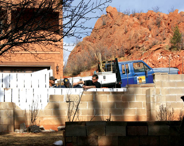 Workers were busy this week installing a retaining wall
behind the White familys existing wall along the south side
of the alley. The alley is between the Whites and a duplex
project in the 3300 block of West Kiowa. The rock formation
is in the project area. A disagreement led to the unusual side-by-side wall arrangement.
Westside Pioneer photo