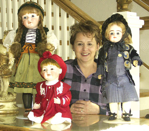 Marilyn Baylen poses with some of her favorite dolls inside her new Doll Doctor location at 8 S. 25th St. 
Westside Pioneer photo