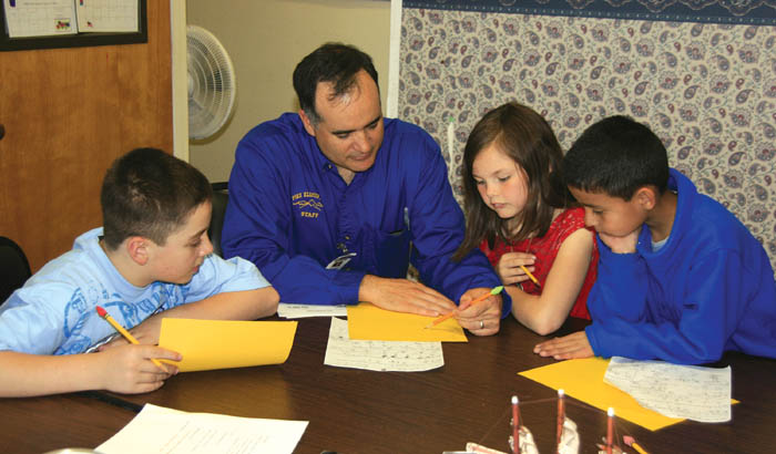 Pike Elementary Principal Manuel Ramsey works with
students during his regularly scheduled math instruction
time. The students are (from left) Andy Laabs, Gabby Hyatt
and Pablo Hernandez. Pike students would relocate to
Jackson, Bristol or Howbert elementaries in 2008-09 under a closure plan that would include the Bijou School moving into the Pike building.
Westside Pioneer photo