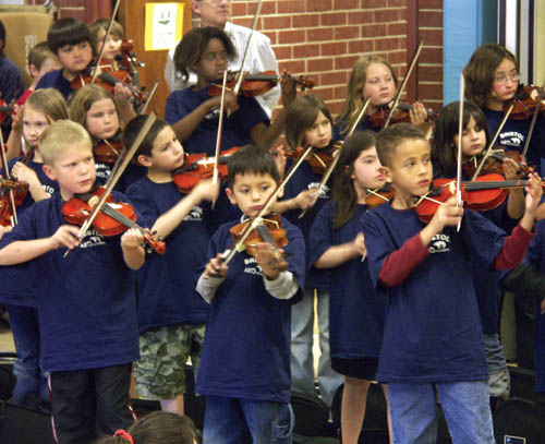Several of Bristol Elementarys 100 Suzuki violinists in
grades 1-3 are shown performing at the first of two shows
in the school gym April 16. The program will expand to K-3
next year.
Westside Pioneer photo