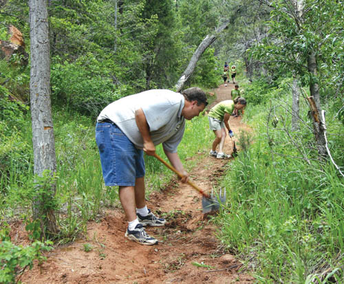 Terry and Debbie Altmayer, who also brought their three
children, widen part of the Roundup Trail during a volunteer
workday in Red Rock Canyon Open Space June 9. 
Westside Pioneer photo