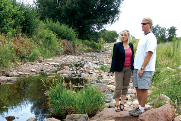 Stephanie Edwards and Barry Brinton of the Gold Hill Mesa
development team take a look at a segment of Fountain
Creek that flows through the north end of the property. A 
proposed creek restoration project would combine Gold
Hill with the City Stormwater Enterprise and Colorado 
Department of Transportation.
Westside Pioneer photo