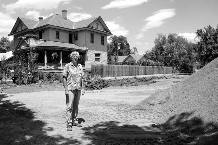 Richard Mee stands next to the large dirt pile (partially
shown at right), in front of his house at 1710 W. Pikes Peak
Ave. and near the hole (hidden by the dirt pile) being dug for the new house he plans to build.
Westside Pioneer photo