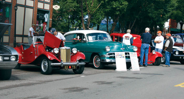 Spectators  check out a diverse array of vehicles in the
2600 block of Colorado Avenue around 9 a.m. Aug. 17, near the start of the 17th annual Old Colorado City Car 
Show. Warm sunshine and t-shirts later gave way, at least for a while, to rain, jackets and umbrellas.
Westside Pioneer photo