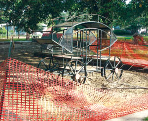 The venerable stagecoach sits in Thorndale Parks under-construction area, wating to be joined by new 
playground equipment.
