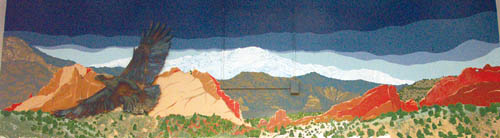 A soaring eagle appears to be part of teacher Gary 
Cummings recently painted mural at Whittier Elementary, 
but in reality its a separate, previously mounted art piece made of steel that he incorporated into his Garden of the 
Gods/Gateway Rocks scene, titled Pikes Peak Region. Note also the electrical outlet box and conduits. Cummings 
and his mother used recycled house paint over the summer to color in the work.
							Westside Pioneer photo