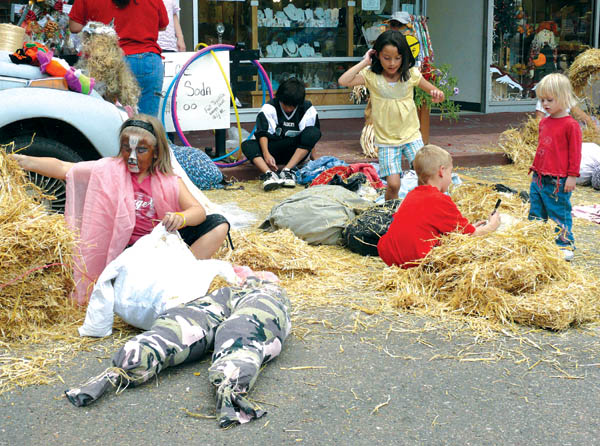 Kids use plenty of straw for the Old Town Plaza merchants scarecrow-making contest Saturday, Sept. 27. 
Westside Pioneer photo
