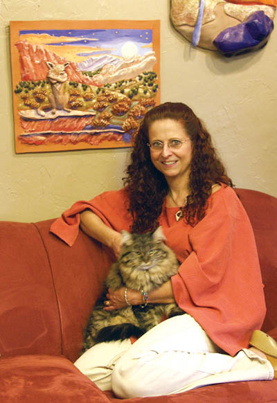 Deb Komitor and pet cat pose in front of a clay piece titled 'Home.' It is one of the works that is featured in her book, 
'In Honor of My Father.' 
Westside Pioneer photo