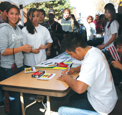 Henry Cejudo signs autographs for Coronado High students
in the school commons area Oct. 28 after an assembly
recognizing the Cougar alum for winning an Olympic wrestling gold medal this year. 
Westside Pioneer photo