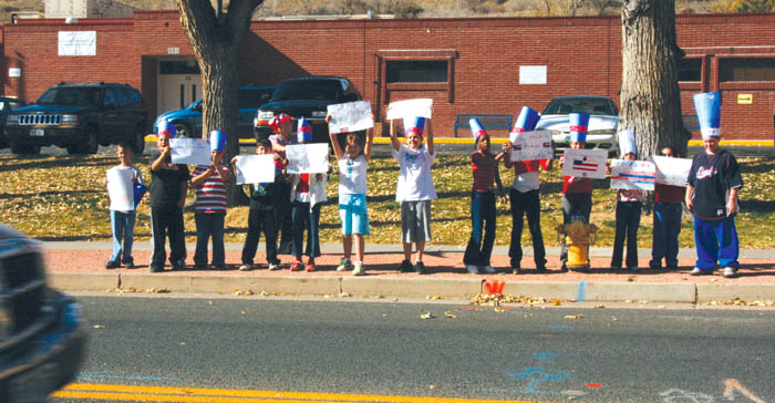 With Bristol Elementary a polling place Nov. 4, students
from Jackie Thompsons fifth-grade class stand in front of
their school along Walnut Street, reminding a passing motorist to vote. Inside, students held a mock presidential election.
Westside Pioneer photo