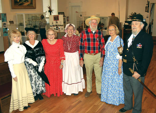 Dressed for the occasion at the 10th anniversary
celebration Nov. 3 inside the Old Colorado City History
Center were (from left) Barbara Barbaro, Kathy McBride, Lucille Cunningham, Jan Knox, Don Ellis (as Luther McKnight), Kay Atteberry and Dave Hughes 
(holding up an 1860s-era cavalry sword).
Westside Pioneer photo