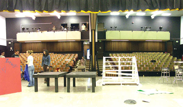 Coronado drama teacher Elizabeth Kahn (wearing jacket)
and students in the production of the musical Grease work
on sets inside the school auditorium, which will be essentially
gutted in a renovation project to start next summer that will
add a balcony and more than twice as much seating. The
project will also add off-stage space for set development
and other performance needs. Note the auditoriums center
division that limits the current seating.
Westside Pioneer photos