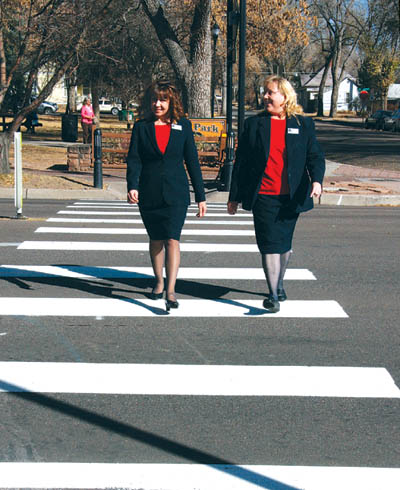 Candi Holland (left) and Sheila Hubbard of Pikes Peak National Bank try out the new pedestrian-activated LED 
crossing that City Traffic Engineering just installed on the west side of Colorado Avenue at 24th Street. The duo found that not all drivers stopped for them.
Westside Pioneer photo
