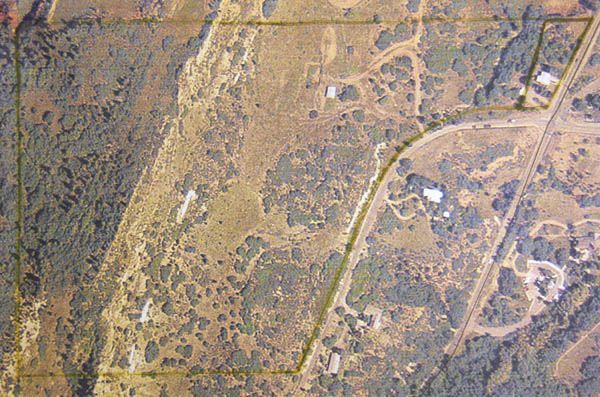 An aerial map, oriented north, shows the extent of the
nearly 50-acre White Acres property (outlined in yellow). The area to be developed would be on the lighter areas
below the hogback/ridge. Note at upper right the house the White family built at 26th Street and Gold Camp Road,
which is set for demolition in the current development plans.
Courtesy of Friends of Red Rock Canyon