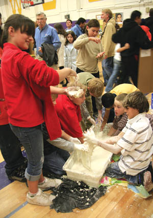 At the West Science Fair Nov. 27... Students try out the cornstarch exhibit, provided by Cool Science. According to 
Ben Schleifer of the non-profit foundation, cornstarch is so tough its being considered for bulletproofing.
Westside Pioneer photo