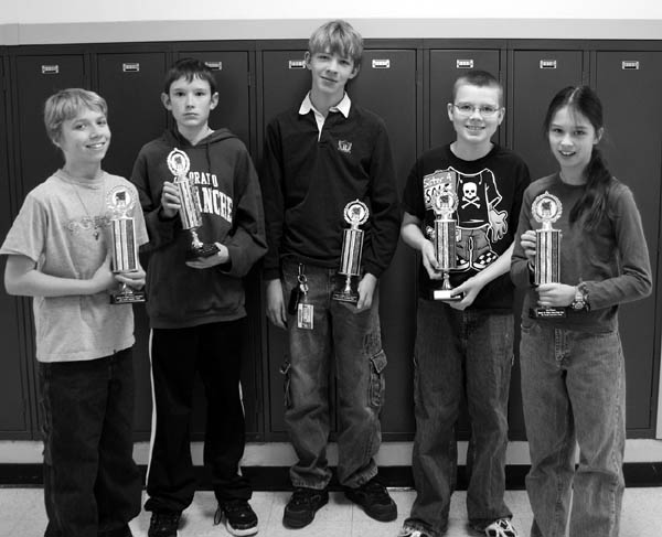 The individual champions on West Middle Schools math team hold up five of the six first-place team trophies that
the school garnered in the competition against six District 11 schools Dec. 8. They are (from left)  Ian Carroll, James
Disney, Jacob Carson, David Lang and Moriah Yeh. In all, West won five individual and six team firsts out of 18
possible at the event. The West team had 27 members in all. 
Westside Pioneer photo