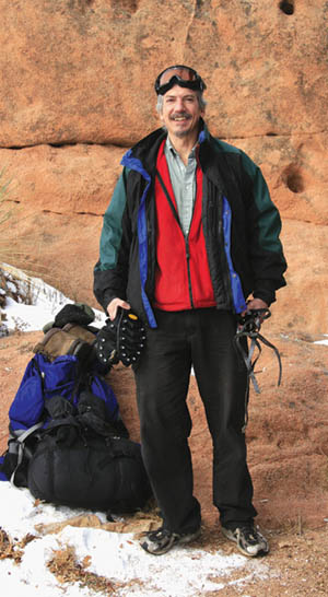 Standing by the start of the hiking trail near his Westside
house, Mark Szabo displays the gear he will be lugging up Pikes Peak with the AdAmAn club on New Years.
Westside Pioneer photo